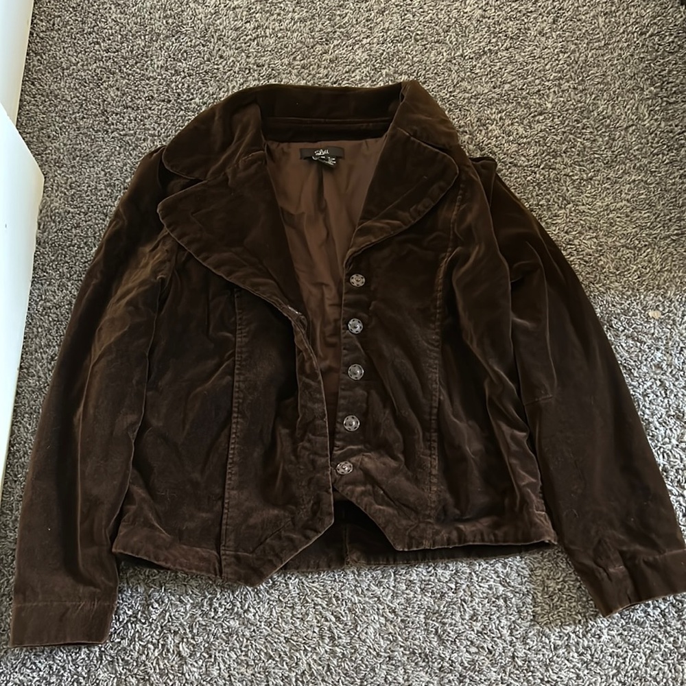 brown jacket with bird on the back